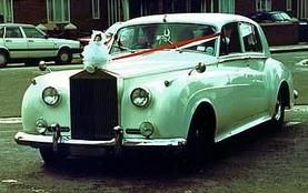 Car decorated with red and white ribbons