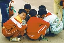 Children crouch in circle.