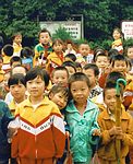 Group of young Chinese children gather for photograph.