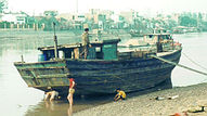 Vietnamese men repair boat.