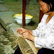 Coolie hat making on street in Tongmu