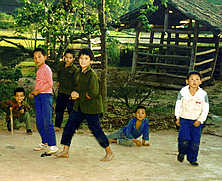 Group of boys on dirt track.